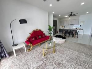 uma sala de estar com um sofá vermelho e uma cozinha em Country Garden Danga Bay 2 Rooms 2 Bathrooms by KS em Johor Bahru