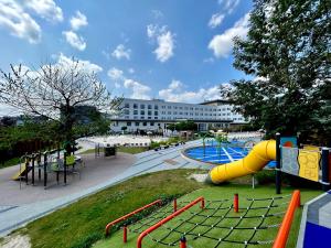 a playground with a slide in a park at Hotel Swing in Kraków