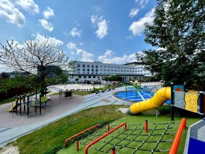 a playground with a slide in a park at Hotel Swing in Krakow