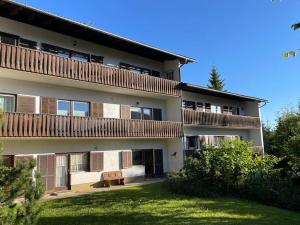 an apartment building with a lawn in front of it at Koralm Appartement 7 in Wolfsberg