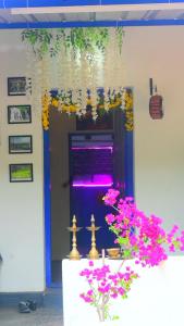 a room with a table with flowers and a purple door at The Camptime Forest Stay in Suntikoppa