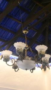 a chandelier is hanging from a ceiling at The Camptime Forest Stay in Suntikoppa