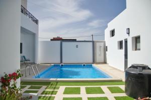 a swimming pool in the backyard of a house at Lovers Villa Somone in Somone