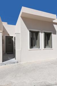 a white house with a driveway at Alesio's house in Ermoupoli