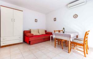 a living room with a red couch and a table at Apartment in Porec/Istrien 10280 in Poreč