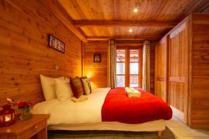 a bedroom with a bed in a log cabin at Chalet Panoramique by Chalet Chardons in Tignes