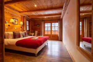 a bedroom with a bed in a wooden room at Chalet Panoramique by Chalet Chardons in Tignes