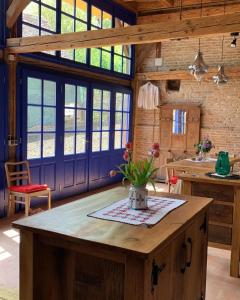 W pokoju z oknami znajduje się kuchnia z drewnianą wyspą. w obiekcie Ani GuestHouse Richis w mieście Richişu