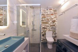 a bathroom with a shower and a toilet and a sink at Ledio's house in Ermoupoli