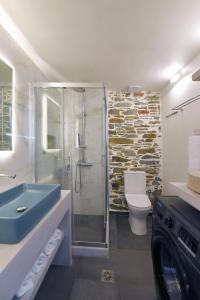 a bathroom with a shower and a sink and a toilet at Ledio's house in Ermoupoli