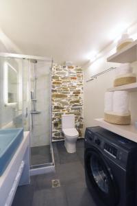 a washing machine in a bathroom with a shower at Ledio's house in Ermoupoli