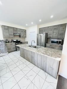 a kitchen with stainless steel appliances and a large island at Niagara Falls Double Bedroom in Thorold