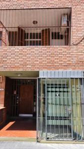 an entrance to a brick building with glass doors at CONSORCIO ARIZU in Mendoza