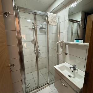 a bathroom with a shower and a sink at mojo otel in Konak