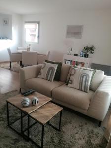 a living room with a couch and a table at Chambre double avec salle de bain commune, a 2 min de la Croisette in Cannes