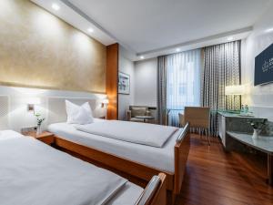 מיטה או מיטות בחדר ב-Hotel Royal