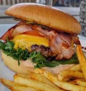 a sandwich and french fries on a plate at Joensuun Tilan Päärakennus in Söderkulla