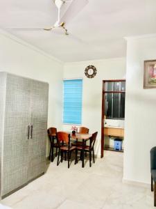 a dining room with a table and chairs at Spacious Holiday Let Wi-Fi & Private Amenities Oyibi in Oyibi