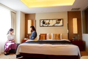 Voodi või voodid majutusasutuse Kokusai 21 International Hotel toas
