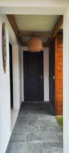 a front door of a house with a black door at Tiny house Les Cactus - Bungalow St Gilles les hauts in Saint-Paul