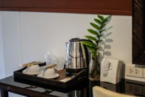 a kitchen counter with a coffee maker and a tea kettle at Hugga Pai in Pai