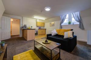 a living room with a couch and a table at Town Centre Retreat - 1 Bed by Apex Stays in Stamford