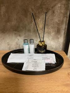 a table with a black plate with two bottles of cosmetics at DEMAL HOTEL in Petropavlovsk