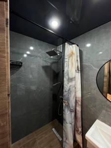 a bathroom with a shower and a sink at DEMAL HOTEL in Petropavlovsk