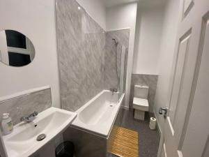 a white bathroom with a sink and a shower at Maritime House One - Hull in Hull