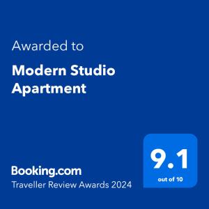 a blue sign with the text awarded to modern studio apartment at Modern Studio Apartment in London
