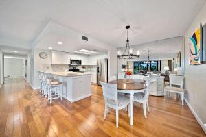 a kitchen and dining room with a table and chairs at Compass Pointe #201 in Sanibel