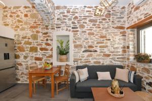 a living room with a stone wall at Ledio's house in Ermoupoli