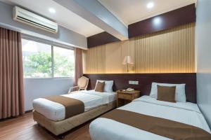 Llit o llits en una habitació de Grand Orchard Hotel Premier