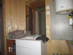 a bathroom with a sink and a mirror at sous les arbres in La Palud sur Verdon