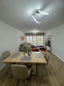 a dining room with a wooden table and chairs at Paradise Garajau in Garajau