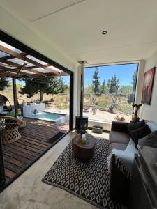 a living room with a couch and a large window at Into The Mystic in Cape Town