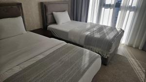 a hotel room with two beds and a window at MH - Act One Act Two - 2BHK- REF3002 in Dubai