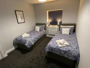 a room with two beds and a mirror at Maritime House Two in Hull