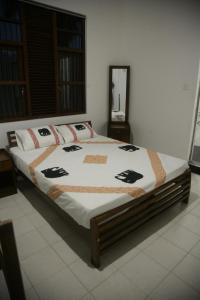 a bedroom with a large bed with white sheets at The Waterbubble Guest in Digana