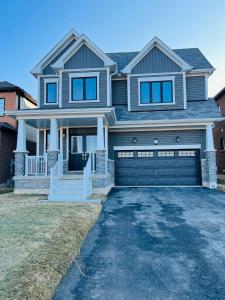 a large house with a garage at Niagara Falls Double Bedroom in Thorold