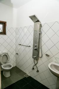 a bathroom with a toilet and a sink at The Waterbubble Guest in Digana