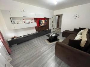 a living room with a couch and a table at AKY Residence in Slănic-Moldova