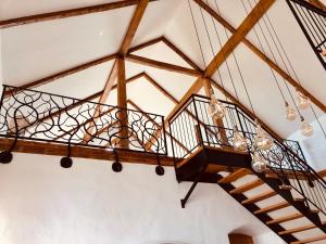 a spiral staircase in a room with wooden beams at Der Hof am Wald in Weichselbaum