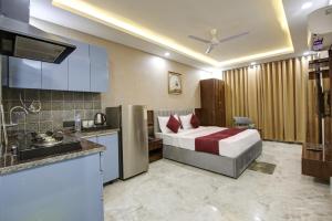 a hotel room with a bed and a kitchen at Limewood Stay - Millennium Huda city center in Gurgaon +60 photos