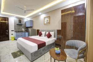 a hotel room with a bed and a table at Limewood Stay - Millennium Huda city center in Gurgaon