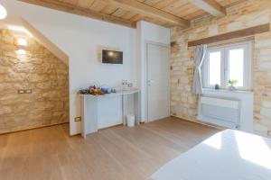 a room with a stone wall and a table and a window at Il Fiore del Conero in Sirolo