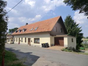 a house with a red roof on a street at Ferienwohnung Unger in Stützengrün