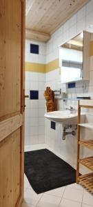 a bathroom with a sink and a mirror at Ferienhaus Lechtaler Alpen in Bach