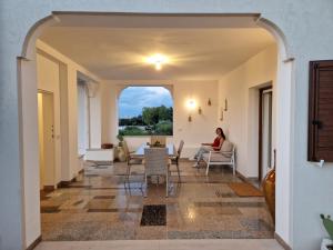 a woman sitting in the living room of a house at Residenza "I Tre Carrubi " in Fasano +66 photos