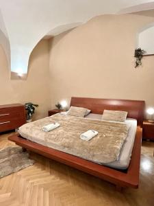 a bedroom with a bed with two towels on it at Apartment Sophie - Old Town in Bratislava
